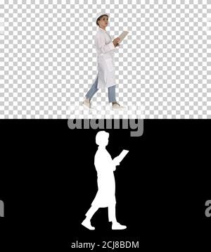 Young technician inspecting and taking necessary notes on digita Stock Photo