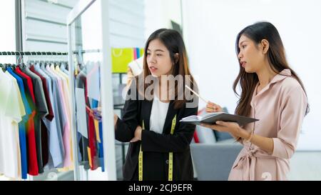Portrait of Asia young designer working in the garment store Stock Photo