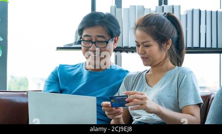 Old man and woman happy with shopping online and using credit card Stock Photo