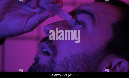 Gamer Programmer Hacker Pouring Medicine Drops In His Eyes Stock Photo