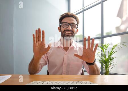 Young man gesturing while talking on video call Stock Photo