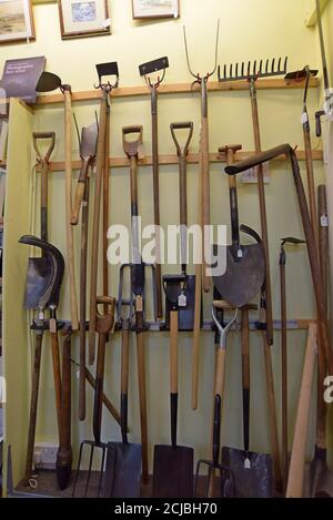 A selection of restored garden tool on sale in an antiques centre in Leominster, Herefordshire Stock Photo