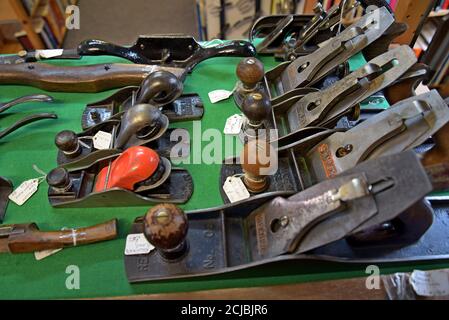 A display of vintage carpenters woodworking planes in an antiques centre in Leominster, Herefordshire Stock Photo