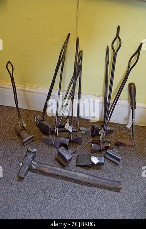 A display of vintage blacksmith's tools in an antiques centre in Leominster, Herefordshire Stock Photo