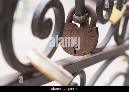 old rusty Padlock on iron fence. Selective focus. Stock Photo