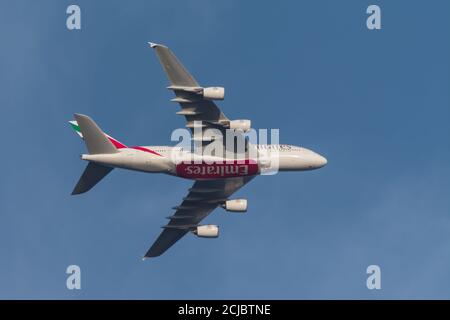 An Emirates Airlines, super jumbo - Airbus A380 passenger aircraft in flight and in mid-air. Stock Photo