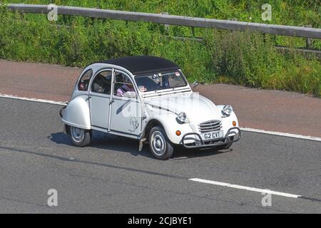 1990 90s nineties white French Citroën 2 CV6 Special; Vehicular traffic moving vehicles, cars driving. French vehicle on UK roads, motors, motoring on the M6 motorway highway network. Stock Photo