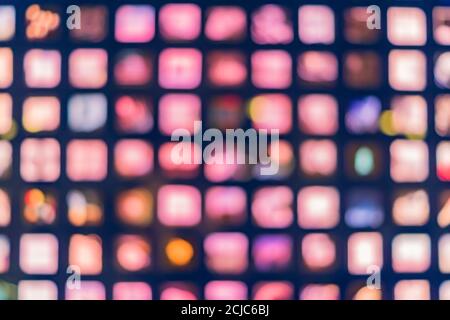 Defocused abstract multicolored bokeh lights background. Square windows at night Stock Photo