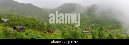 Norwegian style holiday cottages in the misty mountains of northern Norway. Stock Photo