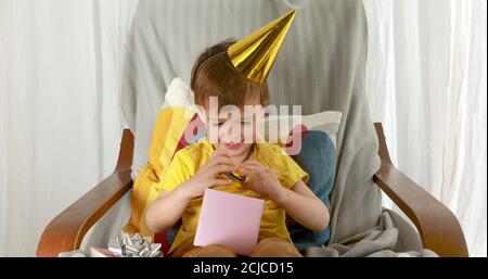 Little boy is looking forward to discovering given gift Stock Photo