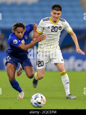 Doha, Capital of Qatar. 14th Sep, 2020. Andre Carrillo (L) of AL Hilal vies for the ball with Odiljon Khamrobekov of Pakhtakor during the AFC Asian Champions League group B football match between AL Hilal of Saudi Arabia and Pakhtakor of Uzbekistan at Al Janoub Stadium in Doha, Capital of Qatar, Sept. 14, 2020. AL Hilal won 2-1. Credit: Nikku/Xinhua/Alamy Live News Stock Photo