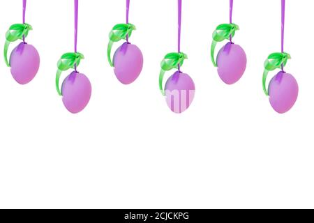 violet easter eggs hang on silk ribbon isolated on white backgound. Easter decoration and celebration concept. Stock Photo