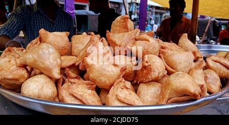 DISTRICT KATNI, INDIA - SEPTEMBER 24, 2019: Fresh samosa displayed at street food carriage shop in market street. Stock Photo