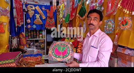 DISTRICT KATNI, INDIA - SEPTEMBER 24, 2019: Religious goods presented for sale at indian festival bazaar season sale by village salesmen. Stock Photo