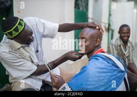 A man having a shave in Marché Sandaga, Dakar, Senegal Stock Photo