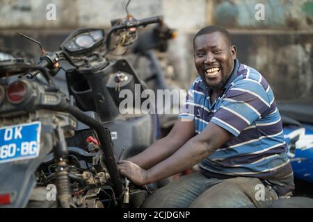A motorbike mechanic in Marché Sandaga, Dakar, Senegal Stock Photo