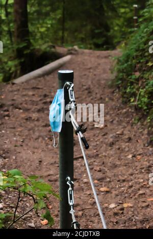 Discarded mask polluting the Nature reserve in Germany Stock Photo