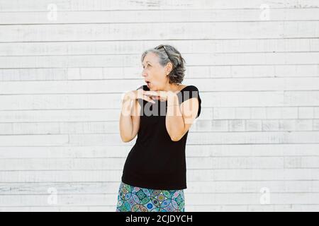 Senior woman making grimace over a white background Stock Photo