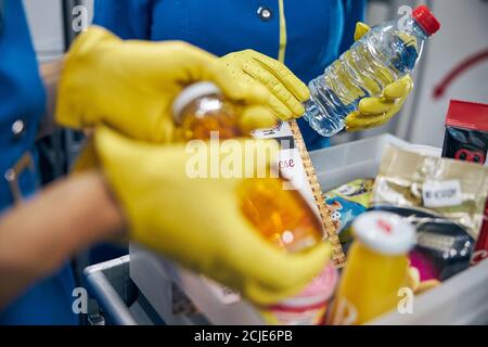 Stewardess handed out drinks on the board of commercial airplane Stock Photo