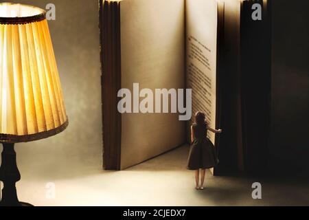 surreal moment of a woman opening the blank pages of a giant book, knowledge concept Stock Photo