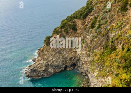 Gorgeous panoramic landscape view of the small cove with its beautiful shallow turquoise blue water. The rocky bay at the coastal area of Cinque Terre... Stock Photo