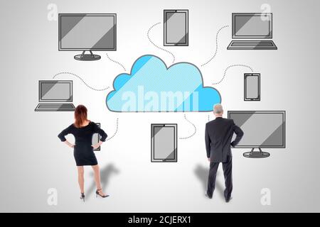 Cloud computing concept drawn on a wall watched by business people Stock Photo