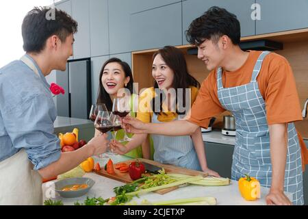 Happy young cook while drinking red wine Stock Photo