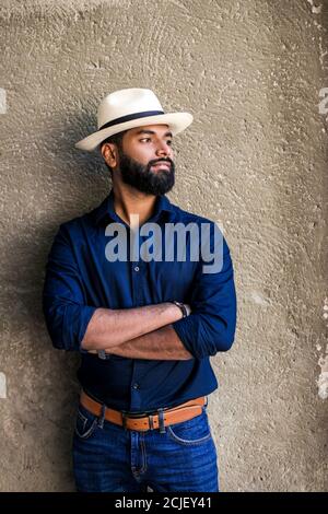 Fashion business man in shirt posing against the stone wall. Stock Photo