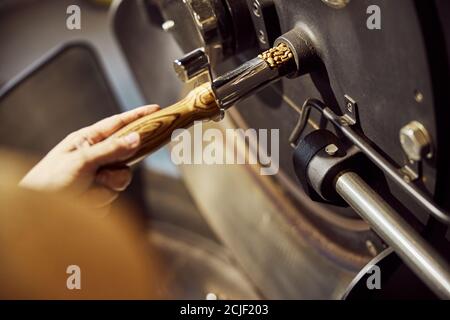 Male worker using industrial coffee roasting machine Stock Photo