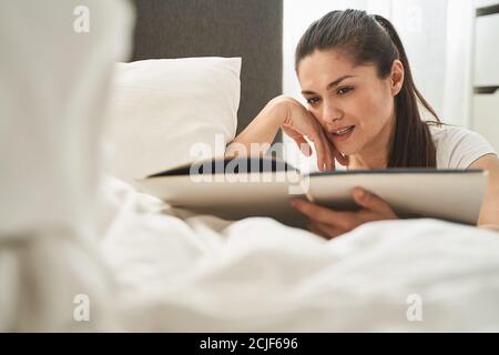 Attractive thoughtful lady viewing her old pictures Stock Photo