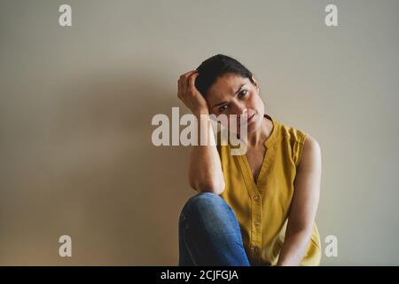 Low-spirited female staring in front of her Stock Photo
