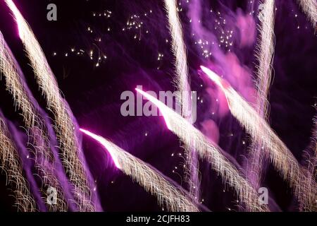 Light trails from the fireworks on a dark background. Stock Photo