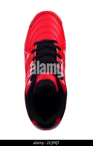 Red sneakers with black laces and white stripes on a white background. Stock Photo