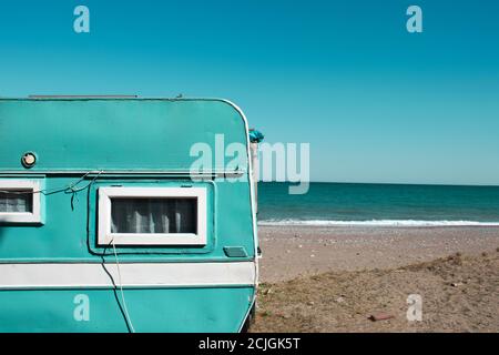 mint green Caravan near the sea. Family vacation travel, holiday trip in motorhome, Caravan car Vacation. Stock Photo