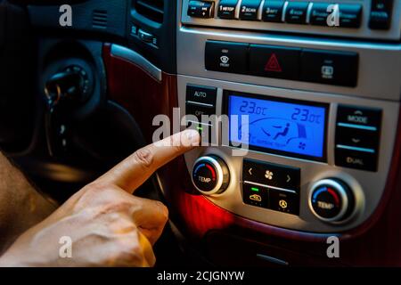 Close up of a man activating Air Conditioner in a modern SUV Stock Photo