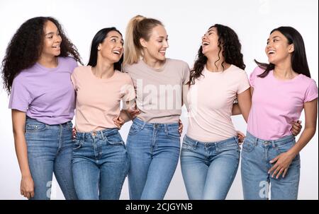 Happy Multiethnic Women Hugging Laughing Standing Together Over White Background Stock Photo