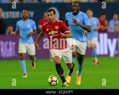 Soccer Football - Manchester City vs Manchester United - International Champions Cup - Houston, USA - July 20, 2017   Manchester United's Henrikh Mkhitaryan in action with Manchester City's Yaya Toure   REUTERS/Richard Carson