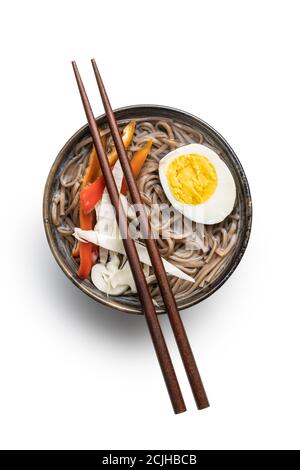 Asian noodle soup with soba noodles, vegetable and egg in bowl isolated on white background. Stock Photo