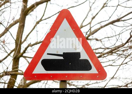 Road signs near the British Army tank training grounds at Bovington Camp in Dorset indicating that there are tanks on and crossing the roads nearby an Stock Photo