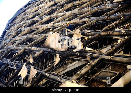 Beirut, Lebanon. 15th Sep, 2020. A worker removes the burnt decoration materials of a building under construction in downtown Beirut, Lebanon, Sept. 15, 2020. A massive fire erupted on Tuesday morning in a building in Beirut's downtown, al-Jadeed local TV channel reported. No casualties were reported. Credit: Bilal Jawich/Xinhua/Alamy Live News Stock Photo