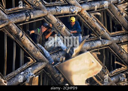 Beirut, Lebanon. 15th Sep, 2020. Workers remove the burnt decoration materials of a building under construction in downtown Beirut, Lebanon, Sept. 15, 2020. A massive fire erupted on Tuesday morning in a building in Beirut's downtown, al-Jadeed local TV channel reported. No casualties were reported. Credit: Bilal Jawich/Xinhua/Alamy Live News Stock Photo