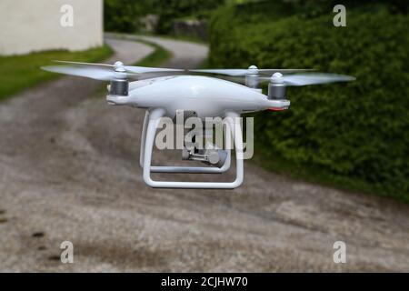 Flying quadcopter with a digital camera on blurred background Stock Photo