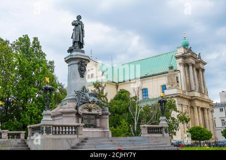 Monument of Adam Mickiewicz and Carmelite church, Krakowskie Przedmiescie, Warsaw, Poland Stock Photo