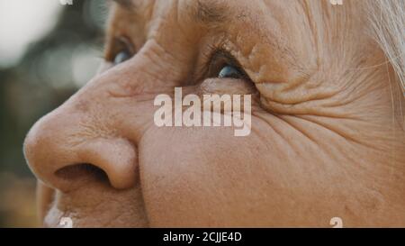 Close up, eyes of old woman in the park. looking up in the sky. High quality photo Stock Photo