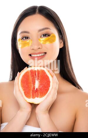 young asian woman with golden eye patches on face holding half of juicy apple isolated on white Stock Photo