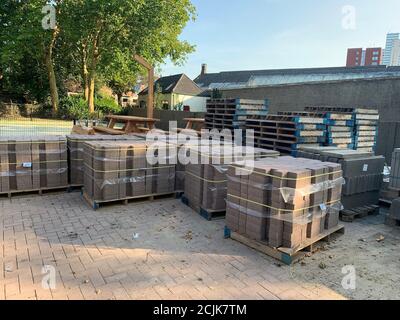 The pallets full of gray landscape bricks for sidewalks. Stock Photo