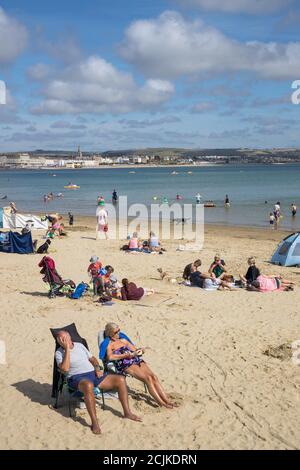 Holidaymakers on the beach, Weymouth, Jurassic Coast, Dorset, England, UK