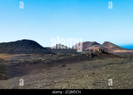 Unique panoramic view of spectacular lava river flows from huge volcano craters. Mountains of fire, Timanfaya National Park, Lanzarote, Canary Islands Stock Photo