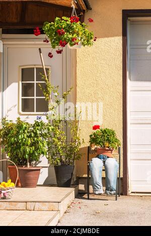 The original decoration of the facade of the house, flowers in pots. Stock Photo