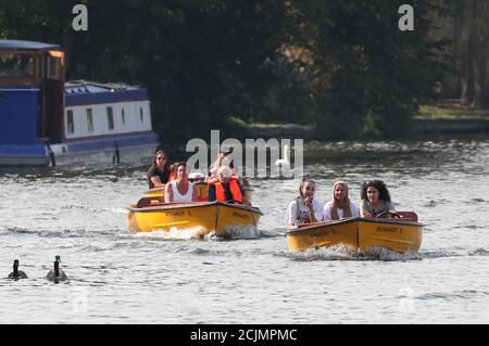 People in boats enjoy the autumn sunshine on the River Thames near Windsor and Eton, Berkshire. Stock Photo